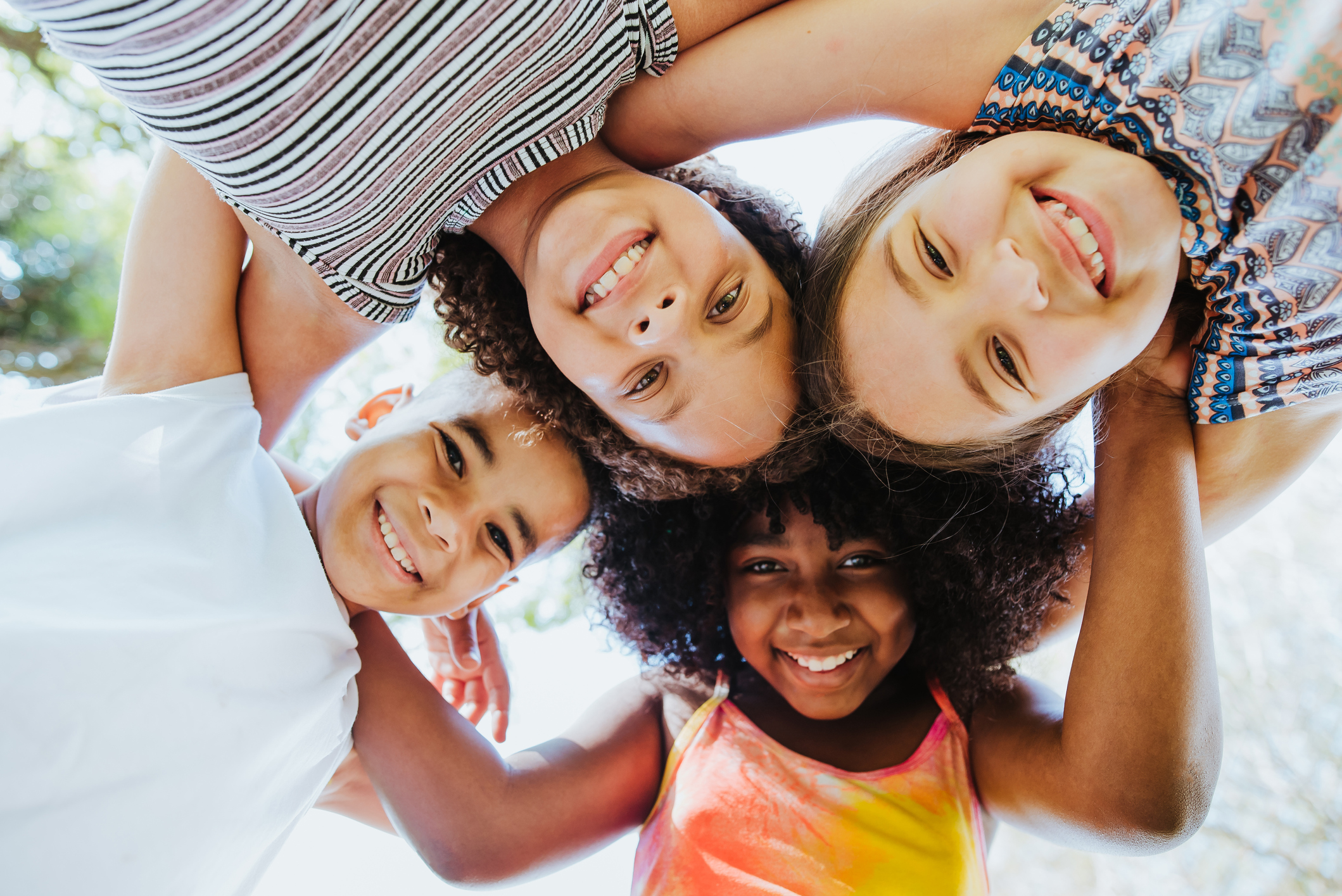 Group of children smiling and looking at the camera.